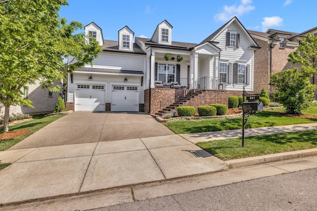 807 Caledonian Ct, Franklin, TN 37064 - view of front facade with brick siding, stairs, driveway, covered porch, and a front lawn