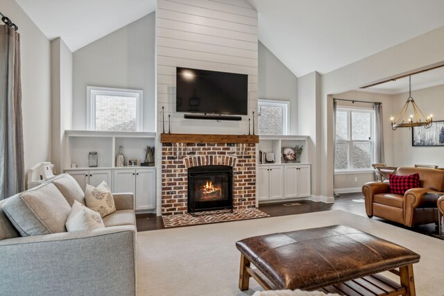 807 Caledonian Ct, Franklin, TN 37064 - living area featuring a chandelier, a brick fireplace, high vaulted ceiling, baseboards, and wood finished floors