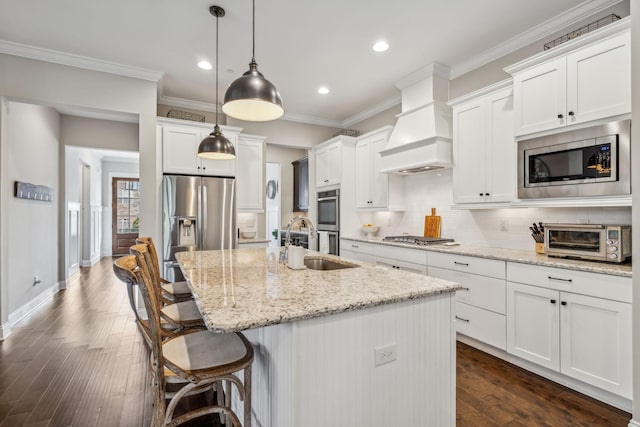 807 Caledonian Ct, Franklin, TN 37064 - kitchen featuring appliances with stainless steel finishes, a sink, recessed lighting, custom range hood, and a center island with sink
