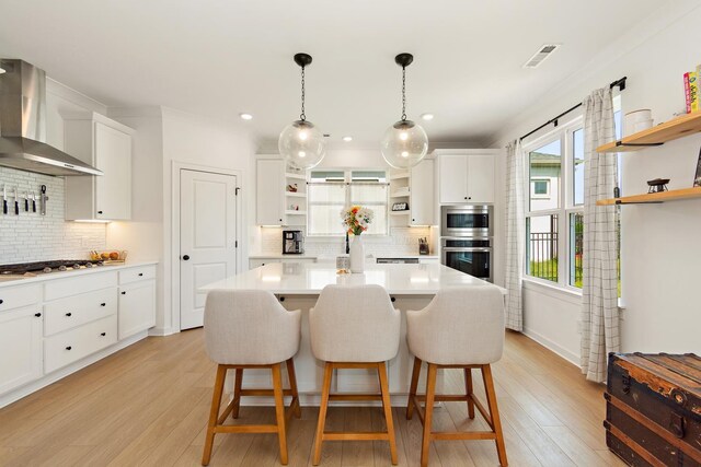 2019 Farm St, Mount Juliet, TN 37122 - kitchen featuring open shelves, wall chimney range hood, appliances with stainless steel finishes, light countertops, and backsplash