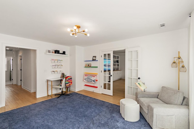 2019 Farm St, Mount Juliet, TN 37122 - living area with french doors, wood finished floors, and a chandelier