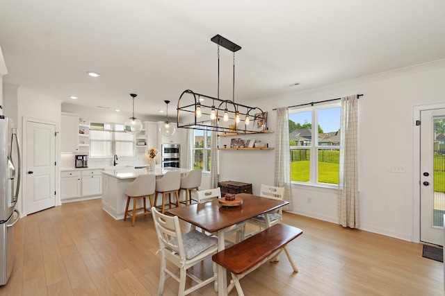 2019 Farm St, Mount Juliet, TN 37122 - dining space with light wood-style flooring, recessed lighting, and crown molding