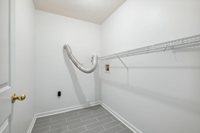 1068 Tulip Grove Rd, Hermitage, TN 37076 - laundry room with hookup for a washing machine, dark tile patterned flooring, and baseboards