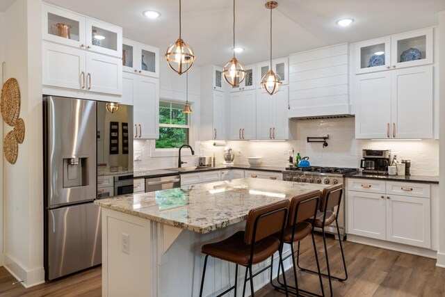 5660 Bold Springs Rd, Mc Ewen, TN 37101 - kitchen with stainless steel appliances, dark wood finished floors, premium range hood, white cabinetry, and recessed lighting
