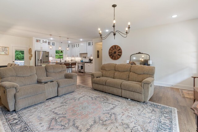 5660 Bold Springs Rd, Mc Ewen, TN 37101 - living room featuring a chandelier, wood finished floors, baseboards, and recessed lighting