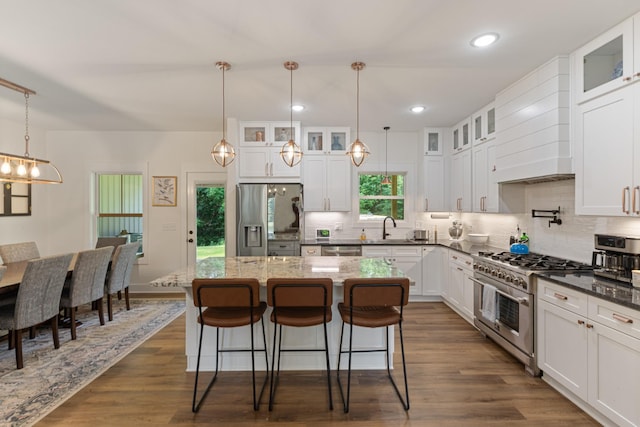 5660 Bold Springs Rd, Mc Ewen, TN 37101 - kitchen with appliances with stainless steel finishes, tasteful backsplash, a center island, a breakfast bar, and recessed lighting