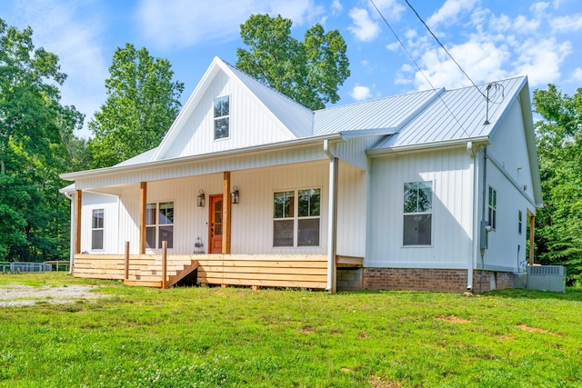 5660 Bold Springs Rd, Mc Ewen, TN 37101 - modern inspired farmhouse with a porch, a front lawn, metal roof, and cooling unit