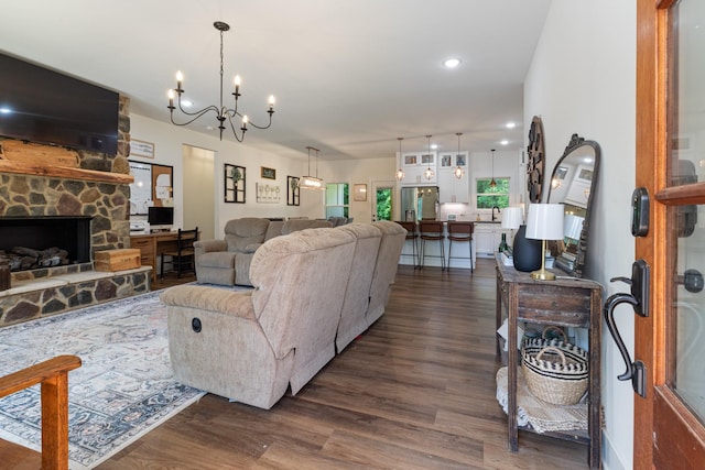 5660 Bold Springs Rd, Mc Ewen, TN 37101 - living room with dark wood finished floors, a chandelier, and a stone fireplace