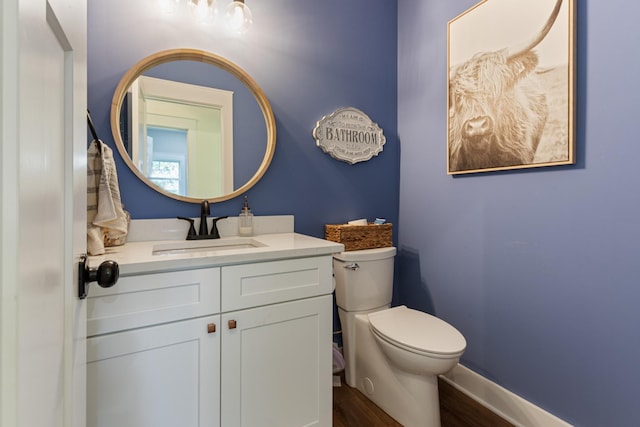 5660 Bold Springs Rd, Mc Ewen, TN 37101 - bathroom featuring toilet, wood finished floors, vanity, and baseboards