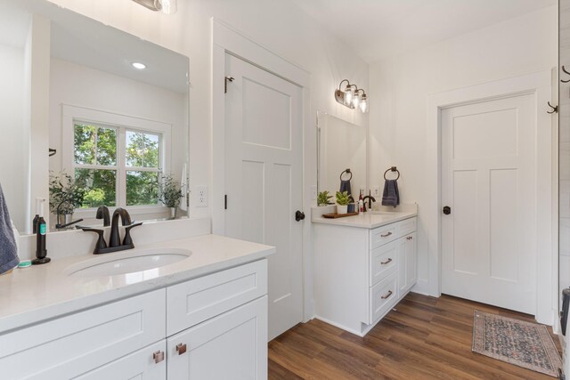 5660 Bold Springs Rd, Mc Ewen, TN 37101 - bathroom featuring two vanities, wood finished floors, and recessed lighting