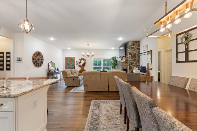 5660 Bold Springs Rd, Mc Ewen, TN 37101 - dining area with a chandelier, dark wood-style flooring, a fireplace, and recessed lighting