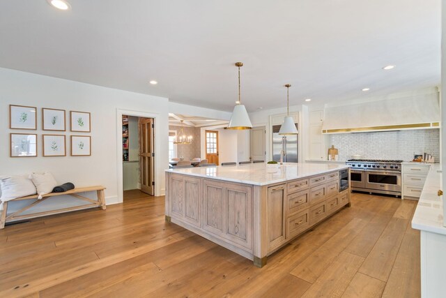 6115 Hillsboro Pike, Nashville, TN 37215 - kitchen featuring high quality appliances, a chandelier, light wood finished floors, tasteful backsplash, and recessed lighting