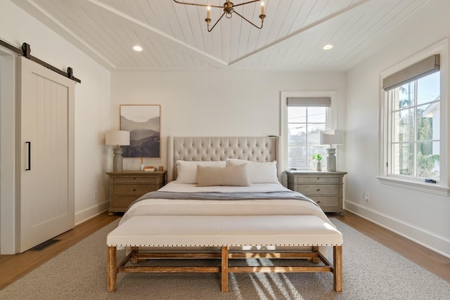 6115 Hillsboro Pike, Nashville, TN 37215 - bedroom featuring wood ceiling, wood finished floors, a barn door, baseboards, and recessed lighting