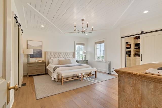 6115 Hillsboro Pike, Nashville, TN 37215 - bedroom featuring a barn door, light wood-style floors, wooden ceiling, a chandelier, and recessed lighting