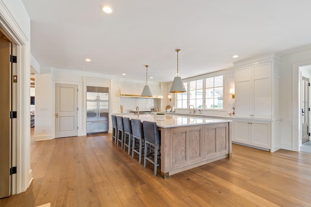 6115 Hillsboro Pike, Nashville, TN 37215 - kitchen featuring stainless steel built in refrigerator, light countertops, backsplash, light wood finished floors, and recessed lighting