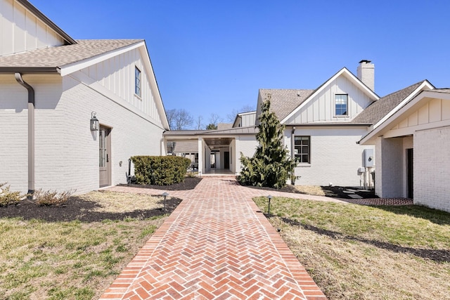 6115 Hillsboro Pike, Nashville, TN 37215 - exterior space featuring board and batten siding, brick siding, and a chimney
