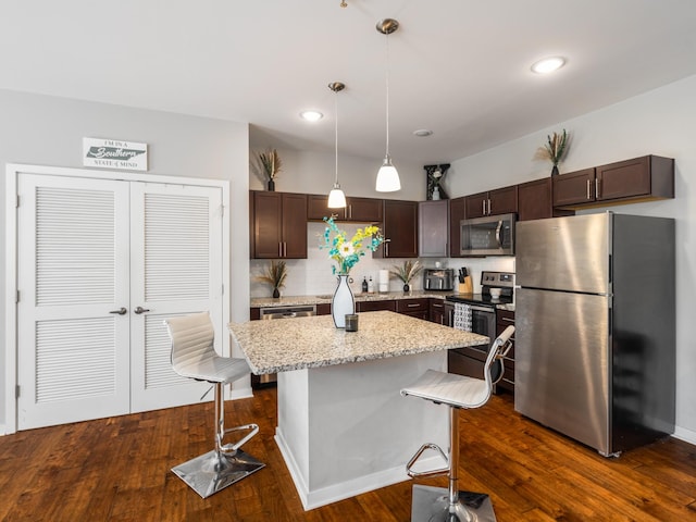 1118 Litton Ave Unit 218, Nashville, TN 37216 - kitchen featuring appliances with stainless steel finishes, dark brown cabinets, pendant lighting, a center island, and a breakfast bar