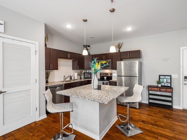 1118 Litton Ave Unit 218, Nashville, TN 37216 - kitchen with appliances with stainless steel finishes, dark brown cabinets, a kitchen bar, backsplash, and a sink