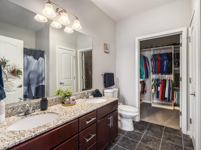 1118 Litton Ave Unit 218, Nashville, TN 37216 - full bath featuring double vanity, toilet, tile patterned floors, and a walk in closet