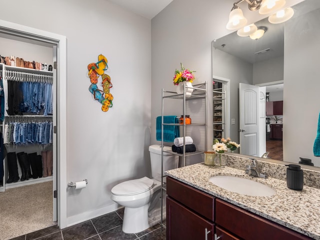 1118 Litton Ave Unit 218, Nashville, TN 37216 - bathroom featuring vanity, toilet, a spacious closet, and baseboards