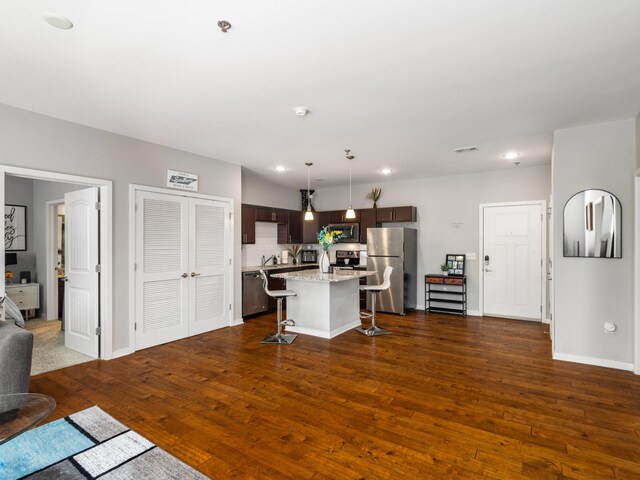 1118 Litton Ave Unit 218, Nashville, TN 37216 - kitchen featuring stainless steel appliances, dark brown cabinetry, a breakfast bar area, dark wood finished floors, and recessed lighting