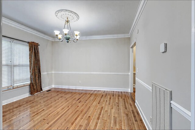 1410 Wall St, Murfreesboro, TN 37130 - spare room featuring a chandelier, crown molding, light wood finished floors, and baseboards