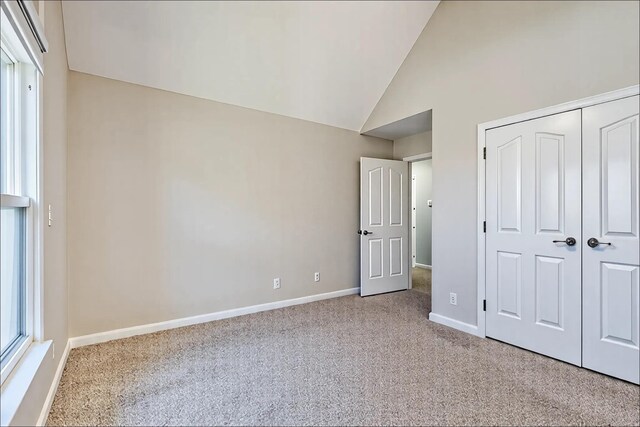 1410 Wall St, Murfreesboro, TN 37130 - unfurnished bedroom with carpet flooring, baseboards, a closet, and high vaulted ceiling