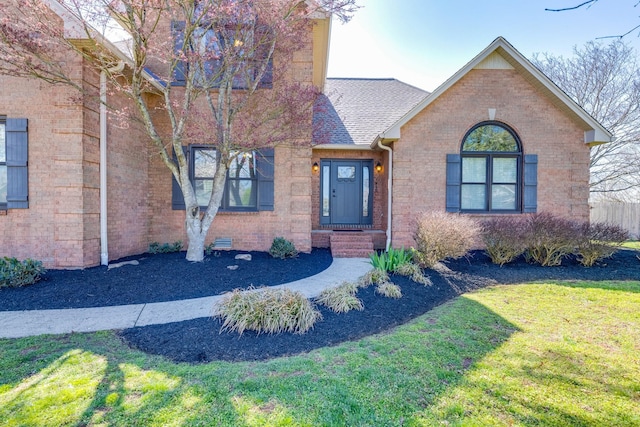 1410 Wall St, Murfreesboro, TN 37130 - view of front of house featuring a front yard, brick siding, and a shingled roof