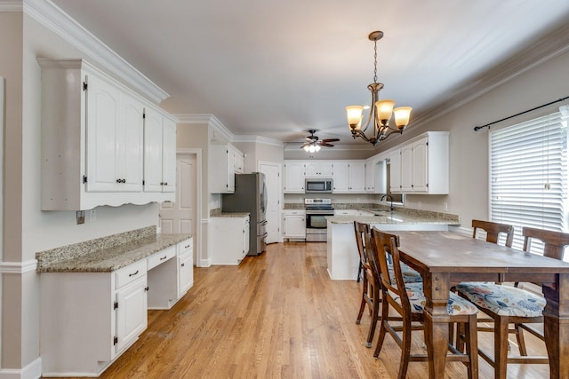 1410 Wall St, Murfreesboro, TN 37130 - kitchen with appliances with stainless steel finishes, a sink, a chandelier, white cabinets, and ornamental molding