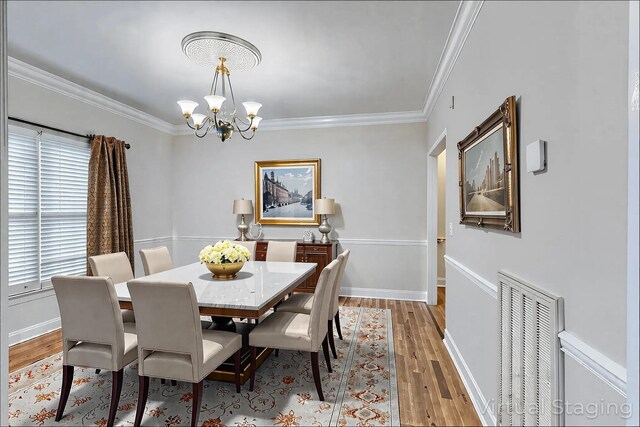 1410 Wall St, Murfreesboro, TN 37130 - dining room with a chandelier, ornamental molding, wood finished floors, and baseboards