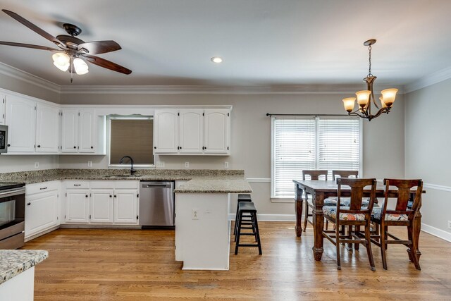 1410 Wall St, Murfreesboro, TN 37130 - kitchen featuring stainless steel appliances, a sink, ornamental molding, a chandelier, and white cabinets