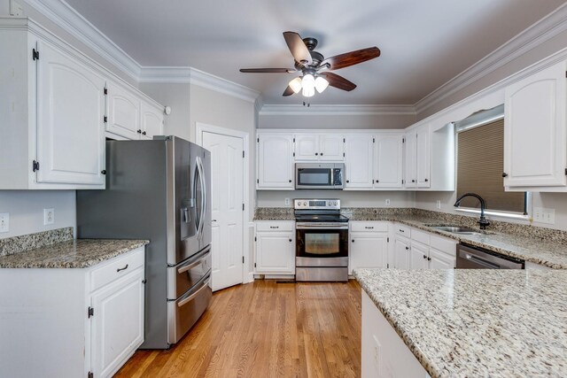 1410 Wall St, Murfreesboro, TN 37130 - kitchen with stainless steel appliances, a sink, ceiling fan, white cabinets, and light stone counters