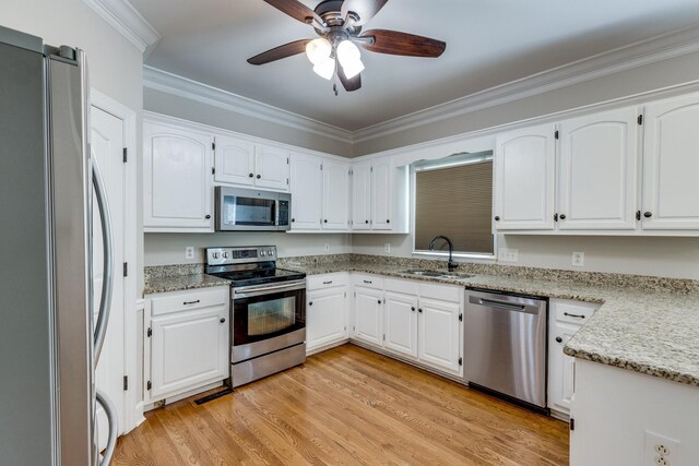1410 Wall St, Murfreesboro, TN 37130 - kitchen with stainless steel appliances, a sink, a ceiling fan, ornamental molding, and white cabinetry