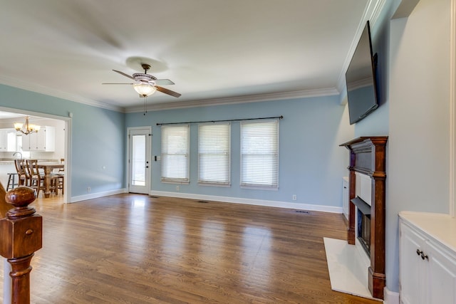 1410 Wall St, Murfreesboro, TN 37130 - unfurnished living room featuring ceiling fan, a fireplace with flush hearth, a chandelier, wood finished floors, and ornamental molding