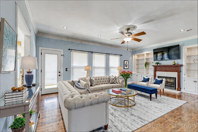 1410 Wall St, Murfreesboro, TN 37130 - living area featuring ornamental molding, a ceiling fan, wood finished floors, a glass covered fireplace, and built in shelves