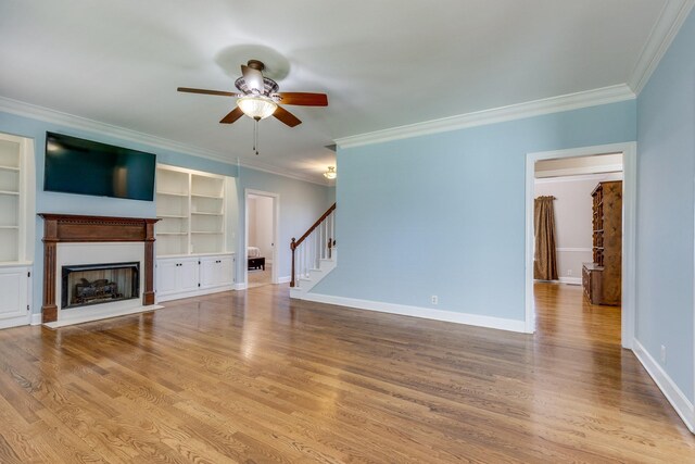 1410 Wall St, Murfreesboro, TN 37130 - unfurnished living room featuring ceiling fan, crown molding, a fireplace, stairs, and wood finished floors