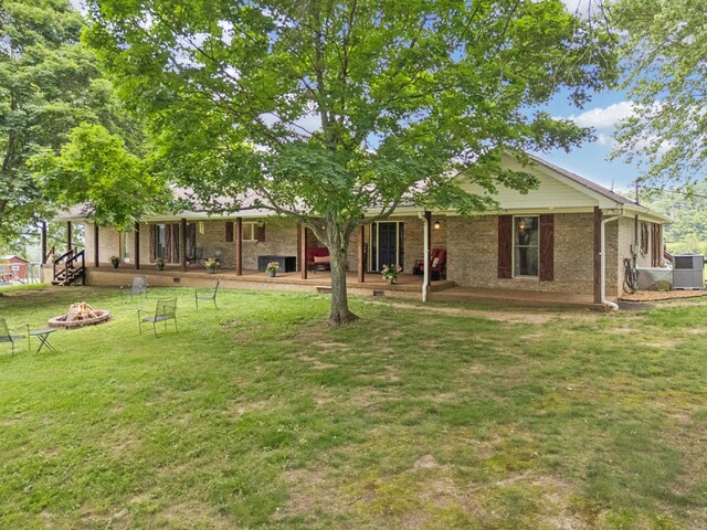 2797 Lewis Rd, Santa Fe, TN 38482 - rear view of property with a yard, a fire pit, and brick siding