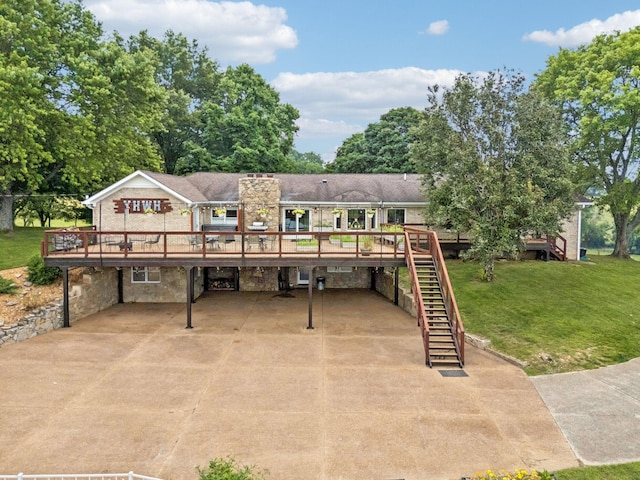 2797 Lewis Rd, Santa Fe, TN 38482 - view of front facade featuring a wooden deck, concrete driveway, stairs, a front lawn, and stone siding