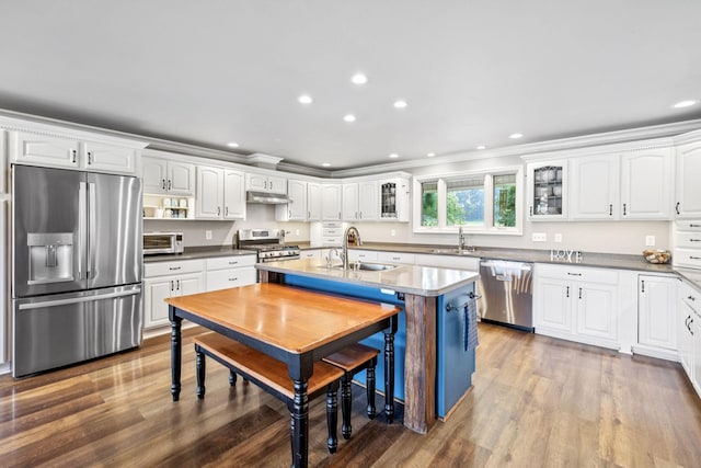 2797 Lewis Rd, Santa Fe, TN 38482 - kitchen with stainless steel appliances, a sink, wood finished floors, white cabinetry, and ornamental molding