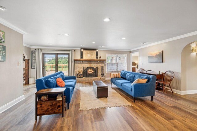2797 Lewis Rd, Santa Fe, TN 38482 - living room featuring arched walkways, baseboards, wood finished floors, a fireplace, and ornamental molding