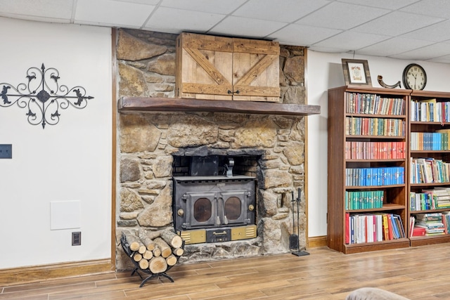 2797 Lewis Rd, Santa Fe, TN 38482 - detailed view of wood finished floors, baseboards, a drop ceiling, and a wood stove