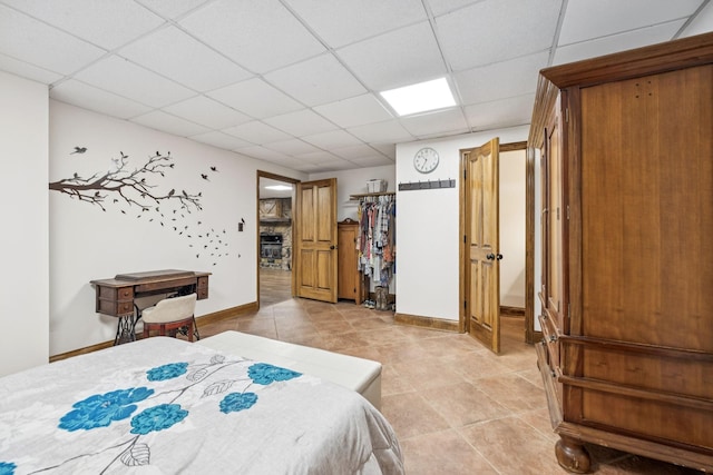 2797 Lewis Rd, Santa Fe, TN 38482 - bedroom featuring a paneled ceiling, light tile patterned floors, and baseboards