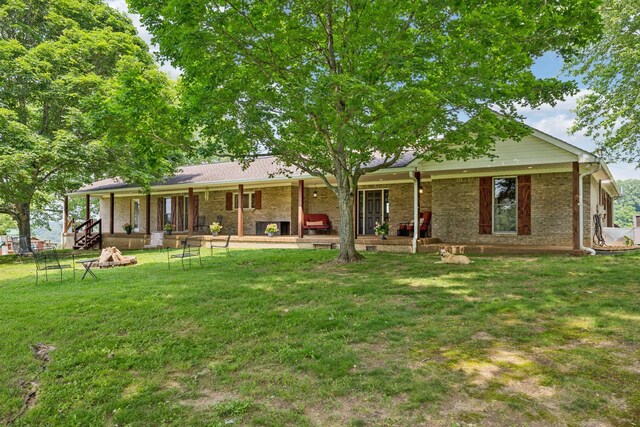 2797 Lewis Rd, Santa Fe, TN 38482 - back of house with a yard, brick siding, and an outdoor fire pit