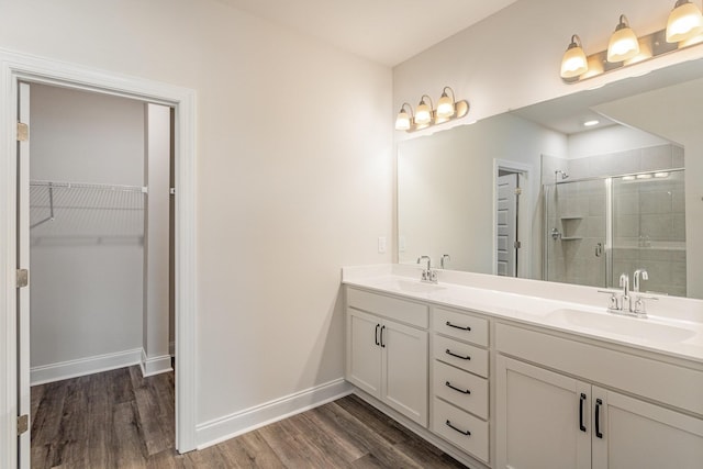 35 Audubon Ln, Murfreesboro, TN 37128 - bathroom featuring double vanity, wood finished floors, a stall shower, a spacious closet, and baseboards
