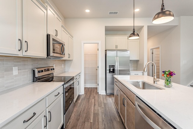 35 Audubon Ln, Murfreesboro, TN 37128 - kitchen featuring appliances with stainless steel finishes, a sink, pendant lighting, dark wood-type flooring, and tasteful backsplash