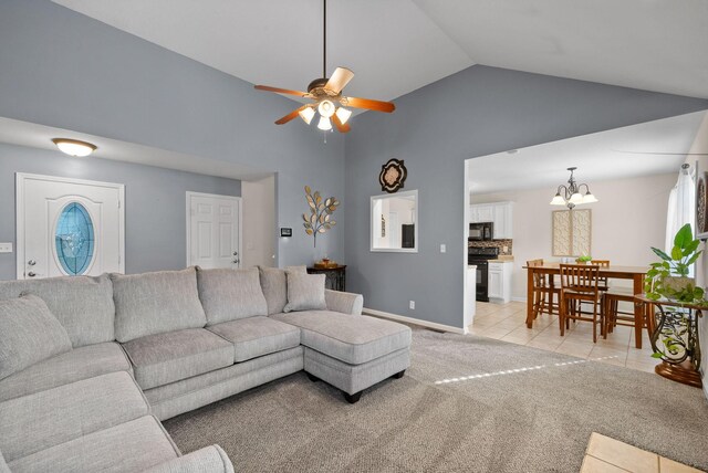 3129 Brook Hill Dr, Clarksville, TN 37042 - living room with light tile patterned floors, high vaulted ceiling, light carpet, ceiling fan, and a chandelier