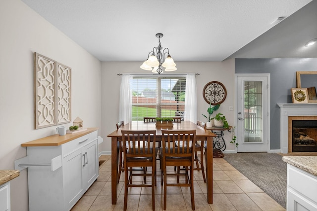 3129 Brook Hill Dr, Clarksville, TN 37042 - dining area featuring a chandelier, plenty of natural light, light tile patterned flooring, and a tiled fireplace