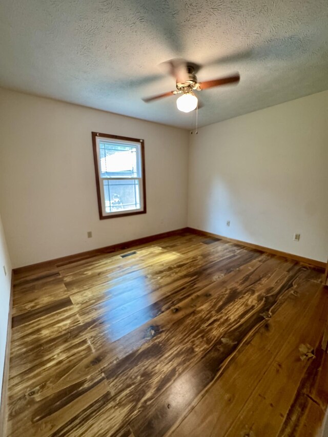 841 Mccord Hollow Rd, Hohenwald, TN 38462 - spare room featuring hardwood / wood-style flooring, ceiling fan, baseboards, and a textured ceiling
