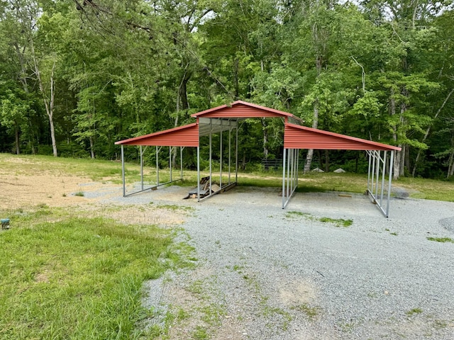 841 Mccord Hollow Rd, Hohenwald, TN 38462 - surrounding community featuring gravel driveway, a view of trees, and a carport