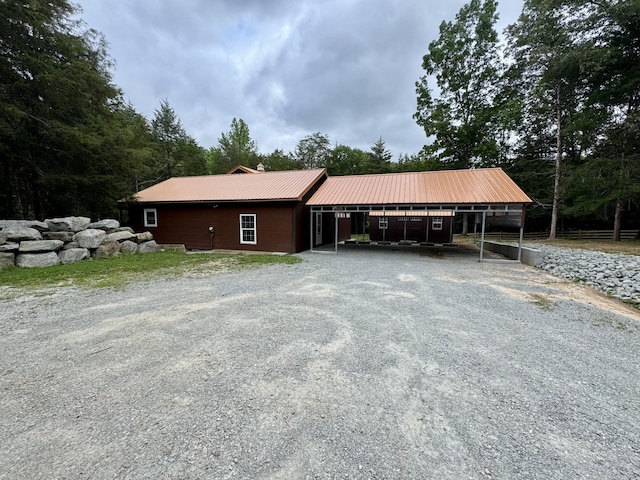 841 Mccord Hollow Rd, Hohenwald, TN 38462 - view of front facade with a carport, driveway, metal roof, and a chimney